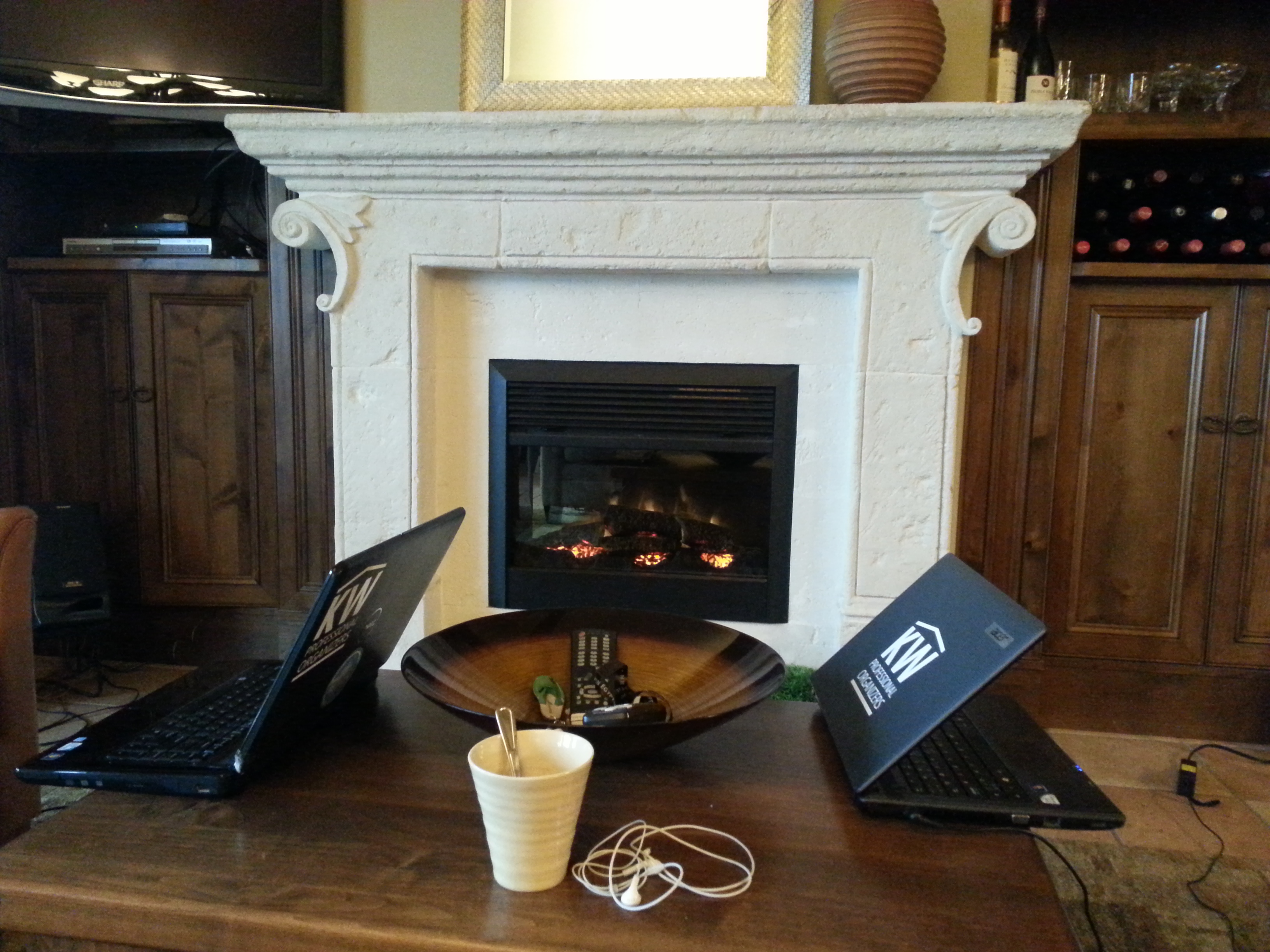 twoclearing digital clutter like laptops in front of fireplace coffee mug