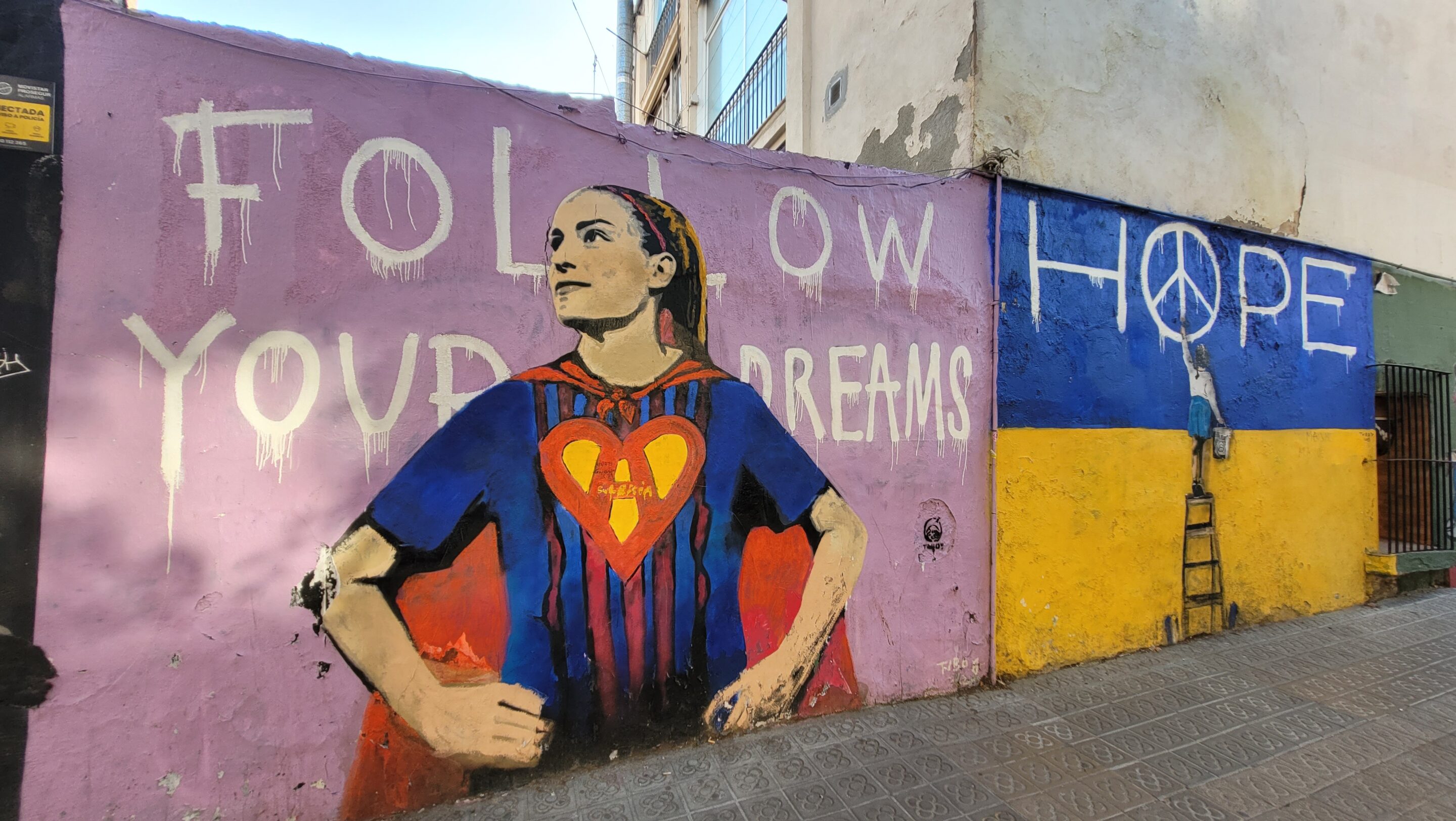 street graffiti with super woman sharing hope and follow your dreams