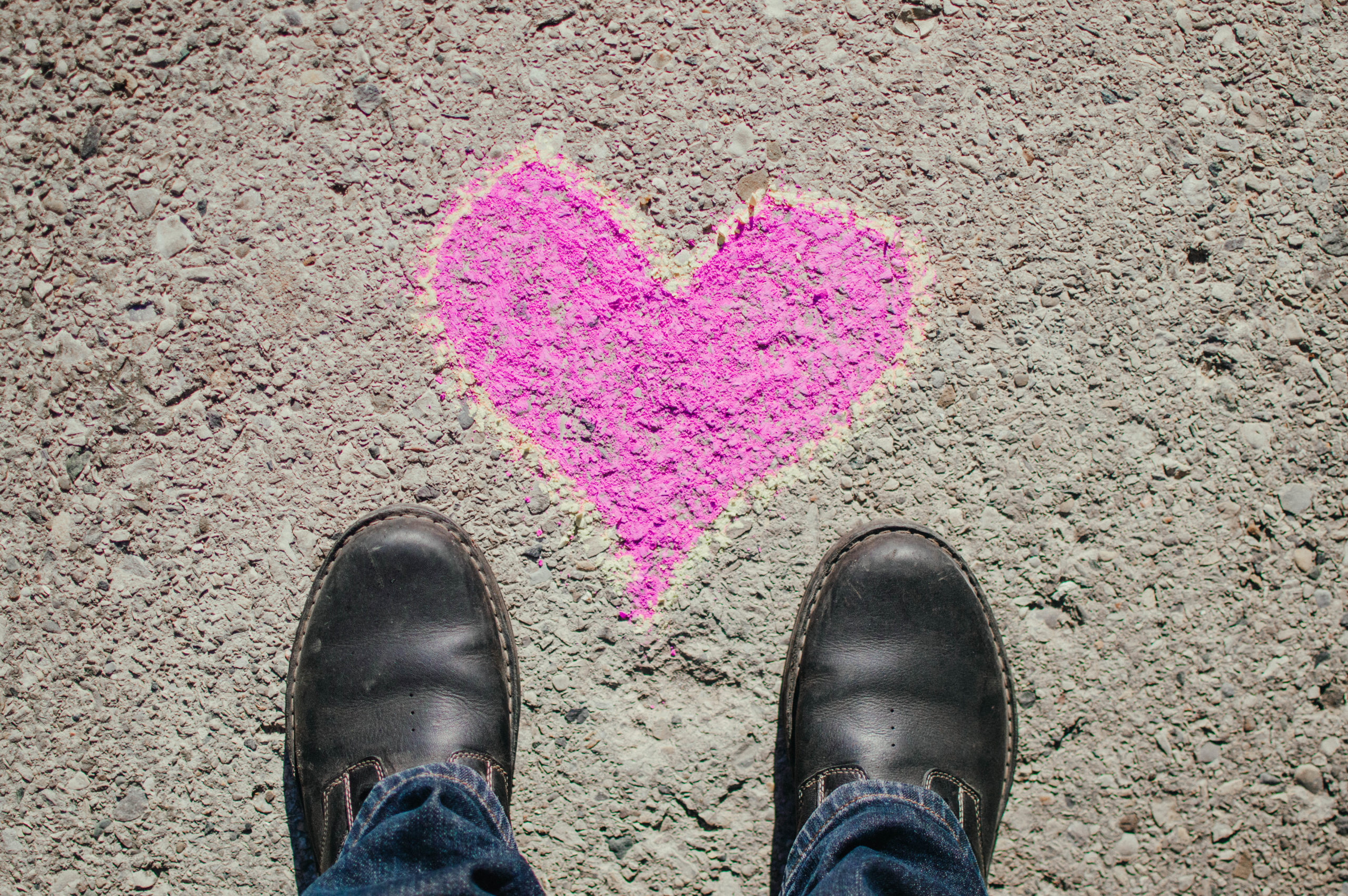 black shoes with heart on sidewalk